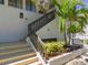 The entrance to the building features stairs, a small garden, and the unit number at 1801 Mariner Dr # 20, Tarpon Springs, FL 34689