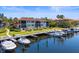 Exterior view of condo complex with boat docks and waterfront access on a sunny day at 1801 Mariner Dr # 20, Tarpon Springs, FL 34689