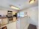 The kitchen features white cabinets, stainless steel appliances, and tile floors at 1801 Mariner Dr # 20, Tarpon Springs, FL 34689