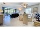 Bright living room featuring tile floors, a ceiling fan, and sliding glass doors to the lanai at 1801 Mariner Dr # 20, Tarpon Springs, FL 34689