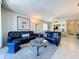 Open living room with tile floors, comfortable seating, and a view of the kitchen at 1801 Mariner Dr # 20, Tarpon Springs, FL 34689