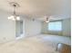 Spacious living room with a fan and a big window for natural light at 8174 Terrace Garden N Dr # 207, St Petersburg, FL 33709