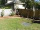 Well-maintained backyard featuring a wooden fence, green grass, and decorative plants providing a private outdoor space at 1857 Bough Ave # C, Clearwater, FL 33760