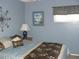 Cozy bedroom features blue walls, decorative wall art, and a comfortable bed with stylish bedding at 1857 Bough Ave # C, Clearwater, FL 33760