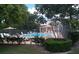 Community pool with lounge chairs, umbrellas, and a shaded cabana area at 1857 Bough Ave # C, Clearwater, FL 33760