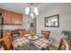 Dining area with glass table and four chairs, adjacent to kitchen at 7296 Marathon Dr # 504, Seminole, FL 33777