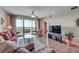 Living room with comfortable seating, large TV, and balcony access at 7296 Marathon Dr # 504, Seminole, FL 33777