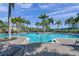 Inviting community pool surrounded by lush landscaping at 7296 Marathon Dr # 504, Seminole, FL 33777