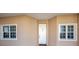 Front door entrance with two large windows on either side at 7296 Marathon Dr # 504, Seminole, FL 33777