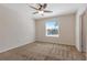 Bright bedroom with carpeted floors and a large window with blinds at 12904 Shady Fern Ln, Gibsonton, FL 33534