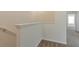 Upper-level hallway with neutral-toned walls and carpeting, showing a staircase at 12904 Shady Fern Ln, Gibsonton, FL 33534