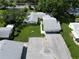 Aerial view featuring the home's light gray roof, long driveway, three-car garage, and well-manicured lawn at 3357 38Th S St # A, St Petersburg, FL 33711