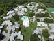 Aerial view showcases pool, tennis courts, and other community amenities surrounded by lush landscaping and homes at 3357 38Th S St # A, St Petersburg, FL 33711