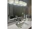 Bathroom with a framed mirror above the sink showcasing the toilet and shower in reflection at 3357 38Th S St # A, St Petersburg, FL 33711
