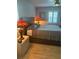 Comfortable bedroom featuring a bed with end tables and shuttered windows at 3357 38Th S St # A, St Petersburg, FL 33711