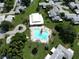 Aerial view showcasing the community pool and clubhouse surrounded by well-manicured lawns and residential buildings at 3357 38Th S St # A, St Petersburg, FL 33711