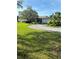 Single Gathering home boasts a well maintained lawn with mature landscaping, a circular driveway, and a charming exterior at 3357 38Th S St # A, St Petersburg, FL 33711
