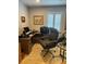 Home office with natural light, wood-look floors, a dark wood desk, and a comfortable executive chair at 3357 38Th S St # A, St Petersburg, FL 33711