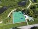 Aerial view of tennis courts and bocce ball surrounded by mature landscaping and ponds in a vibrant community at 3357 38Th S St # A, St Petersburg, FL 33711