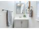 Well-lit bathroom featuring a gray vanity, decorative towel, and a mirror, blending functionality with subtle elegance at 3505 75Th N St, St Petersburg, FL 33710
