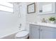 Bathroom with a shower-tub combo, gray vanity, and stylish mirror at 3505 75Th N St, St Petersburg, FL 33710