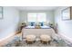 Bedroom featuring a comfortable bed with accent pillows, soft rug, and decorative stools at 3505 75Th N St, St Petersburg, FL 33710