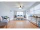 Bright bedroom featuring a ceiling fan, light wood flooring, and a fluffy rug under the bed at 3505 75Th N St, St Petersburg, FL 33710