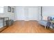 Open bedroom space with wood floors, closet, and accent chair at 3505 75Th N St, St Petersburg, FL 33710