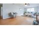 Light-filled bedroom with wood floors, a ceiling fan, and a cozy armchair at 3505 75Th N St, St Petersburg, FL 33710