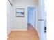 Hallway with wood floors, showing access to rooms and closet space at 3505 75Th N St, St Petersburg, FL 33710