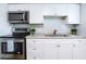 Efficient kitchen with stainless appliances, white cabinets and decorative plants that create a modern and inviting space at 3505 75Th N St, St Petersburg, FL 33710