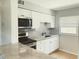 Contemporary kitchen boasting sleek stainless steel appliances, white cabinets, and countertop seating for a modern aesthetic at 3505 75Th N St, St Petersburg, FL 33710