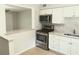 Kitchen with bar counter overlooking the dining and living areas provides an inviting flow to the home's living space at 3505 75Th N St, St Petersburg, FL 33710