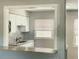 Well-lit kitchen features white cabinetry, modern appliances, and mosaic backsplash, creating a clean and stylish cooking space at 3505 75Th N St, St Petersburg, FL 33710