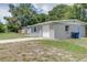 House exterior showcasing a gray painted home with a driveway and garage at 3505 75Th N St, St Petersburg, FL 33710