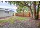 Side yard with a wood fence and grassy area at 3505 75Th N St, St Petersburg, FL 33710