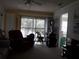 Living room with balcony access and comfortable seating at 101 Lake Ne Ave # 222, Largo, FL 33771