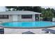 Community pool with lounge chairs and patio at 101 Lake Ne Ave # 222, Largo, FL 33771