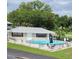 Community pool with surrounding lounge chairs and landscaping at 101 Lake Ne Ave # 222, Largo, FL 33771