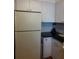 Kitchen features white cabinets and dark countertops at 101 Lake Ne Ave # 222, Largo, FL 33771