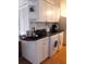 White kitchen cabinets, black countertop, and built-in appliances at 101 Lake Ne Ave # 222, Largo, FL 33771