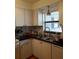 Kitchen with white cabinets, black countertops, and window at 101 Lake Ne Ave # 222, Largo, FL 33771