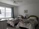 Guest bedroom with two twin beds and ample natural light at 101 Lake Ne Ave # 222, Largo, FL 33771