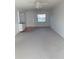 Spacious living room with light gray carpet and ceiling fan at 101 Lake Ne Ave # 222, Largo, FL 33771