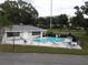 Community pool with lounge chairs and a clubhouse at 101 Lake Ne Ave # 222, Largo, FL 33771