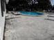 Community pool with lounge chairs and surrounding patio at 101 Lake Ne Ave # 222, Largo, FL 33771