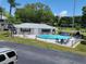 Community pool with surrounding patio furniture at 101 Lake Ne Ave # 222, Largo, FL 33771
