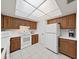 Kitchen features wood cabinets, white appliances, and a tiled floor at 203 Mariner Dr # 203, Tarpon Springs, FL 34689