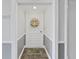Inviting condo entryway with seashell wreath and coastal-themed rug at 203 Mariner Dr # 203, Tarpon Springs, FL 34689