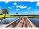 Wooden footbridge over tranquil pond at 203 Mariner Dr # 203, Tarpon Springs, FL 34689